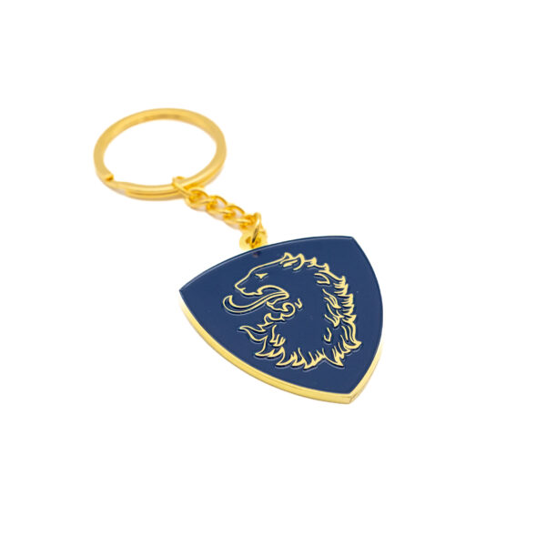 Brelok metalowy złoty, z granatową emalią